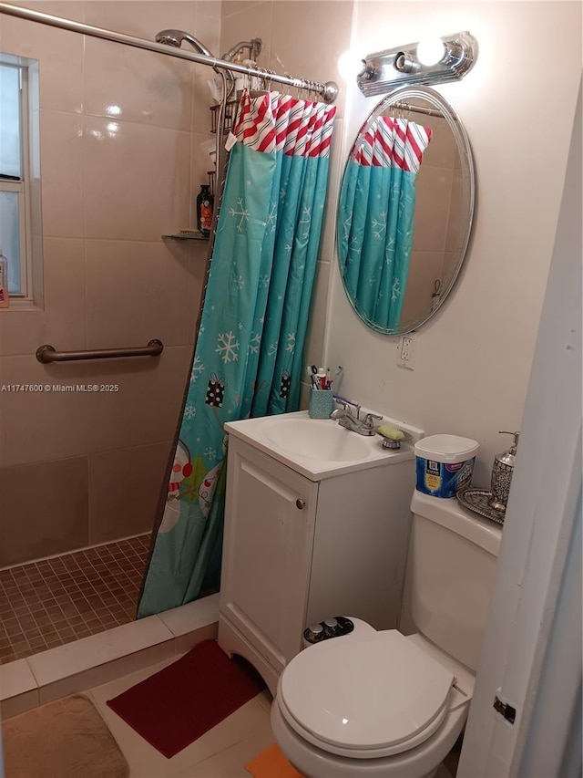 bathroom featuring tile patterned flooring, vanity, toilet, and walk in shower