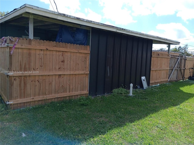 view of outbuilding with a yard