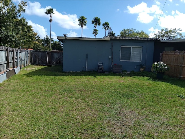 exterior space with central air condition unit and a lawn