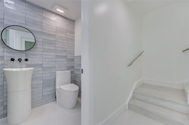 bathroom with tile walls, tile patterned flooring, and toilet