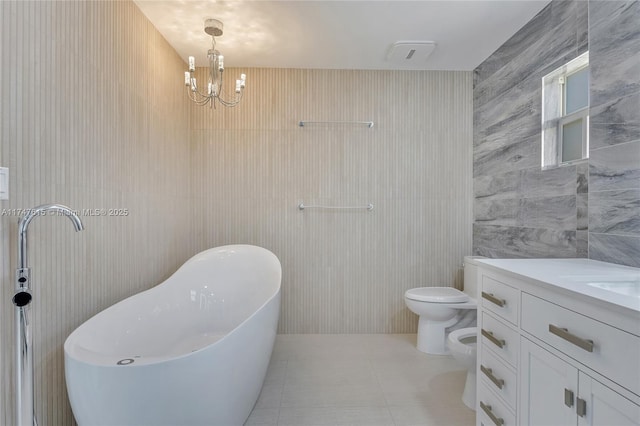 bathroom with a bidet, vanity, a bathing tub, tile patterned flooring, and toilet