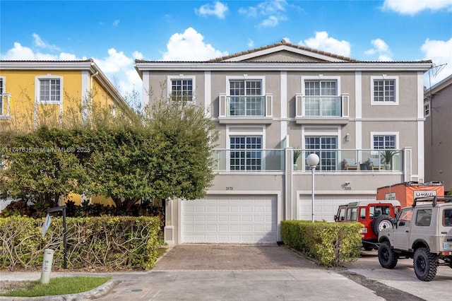 view of front of house featuring a garage and a balcony