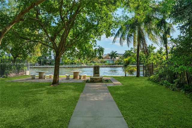 view of home's community featuring a water view and a lawn