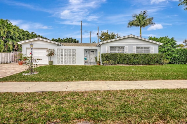 ranch-style house with a garage and a front lawn