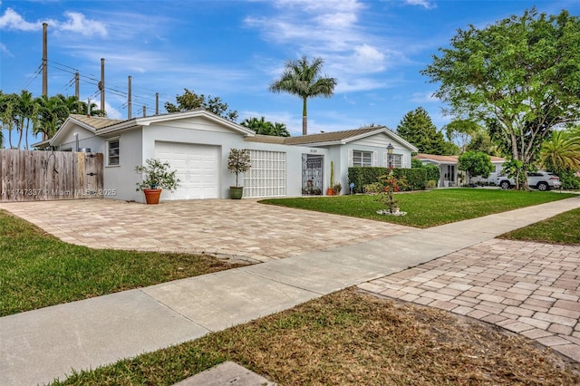 ranch-style home with a front yard and a garage