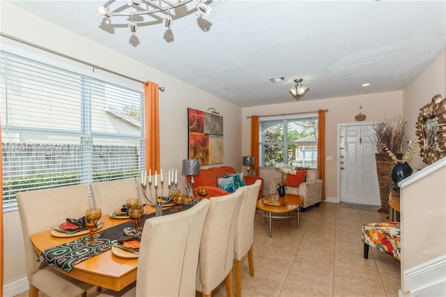 dining area with light tile patterned floors, visible vents, and baseboards