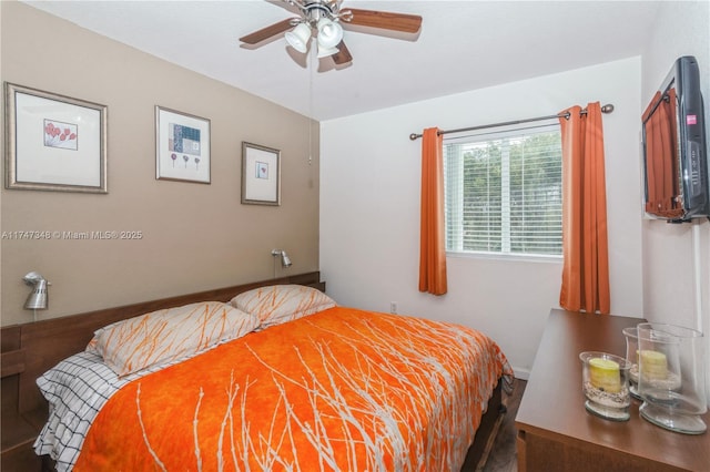 bedroom with a ceiling fan and wood finished floors