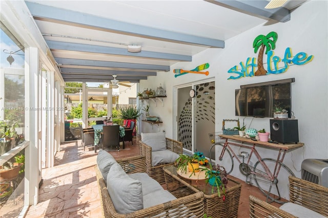 sunroom / solarium with ceiling fan and beamed ceiling