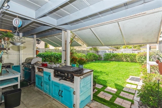 view of patio / terrace with exterior kitchen, area for grilling, and fence private yard