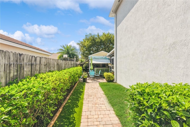 view of yard with a patio and a fenced backyard