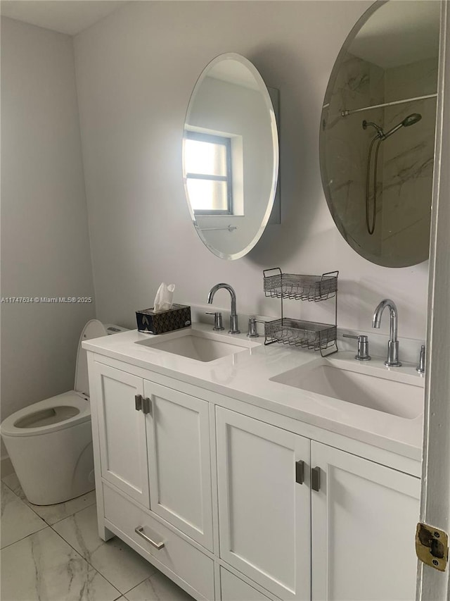 full bath with marble finish floor, a sink, toilet, and double vanity