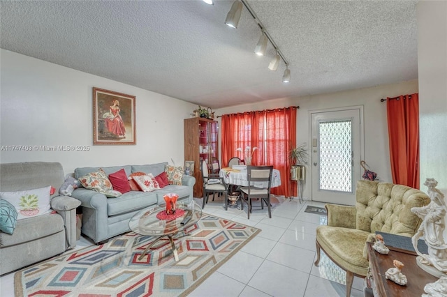 living room featuring a textured ceiling and light tile patterned flooring