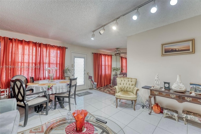 dining space featuring a textured ceiling and light tile patterned flooring