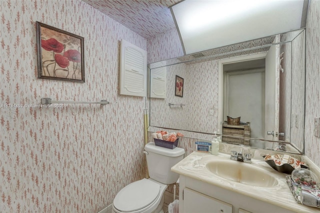 bathroom featuring toilet and vanity