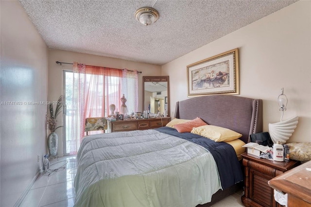 bedroom featuring a textured ceiling and light tile patterned floors