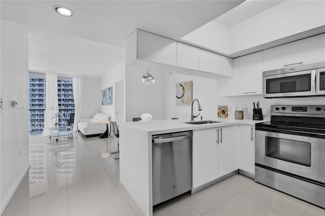 1750 N Bayshore Dr Unit 1602, Miami, FL 33132 - kitchen with stainless steel appliances, a sink, white cabinetry, light countertops, and modern cabinets