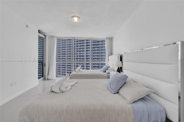 1750 N Bayshore Dr Unit 1602, Miami, FL 33132 - tiled bedroom with a wall of windows, baseboards, and access to outside