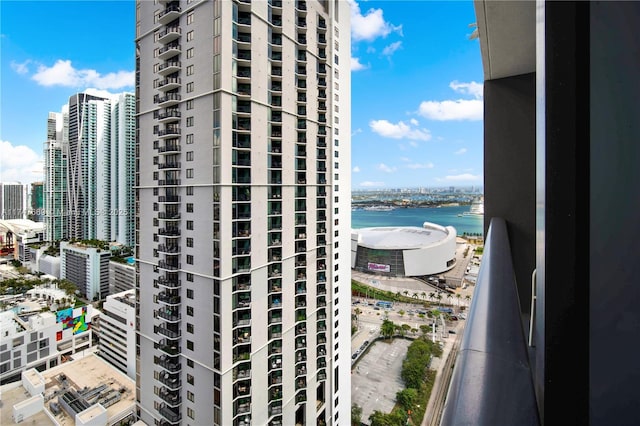 view of building exterior featuring a city view and a water view