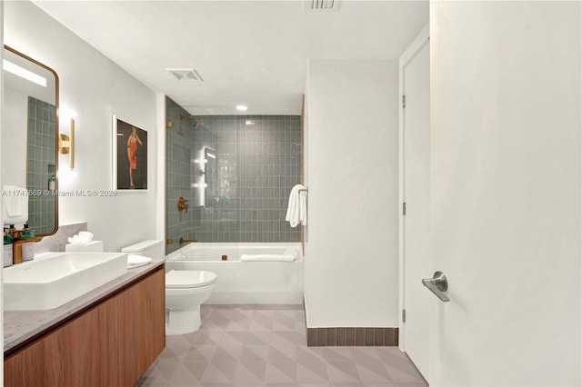 bathroom featuring visible vents, toilet, vanity, and washtub / shower combination