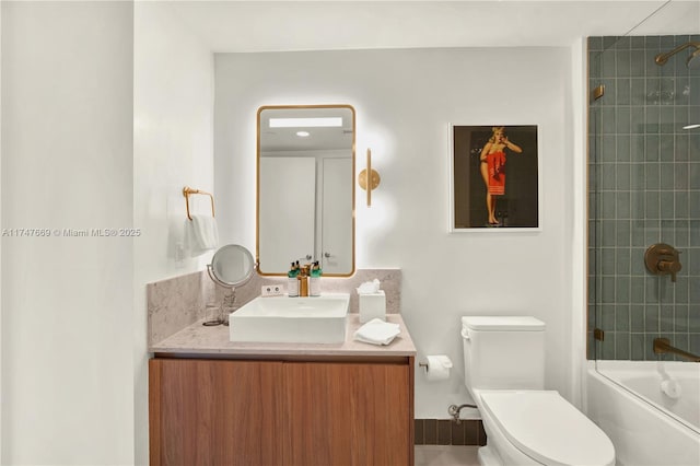 bathroom featuring shower / washtub combination, toilet, and vanity