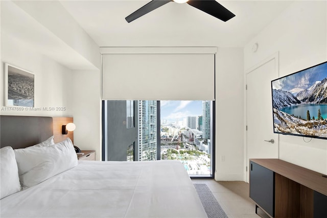 bedroom featuring light tile patterned flooring, a ceiling fan, and access to outside