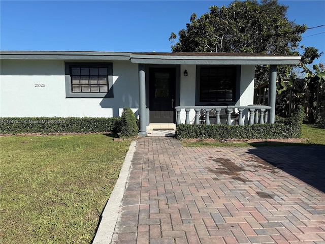 view of front facade with a front yard and a porch