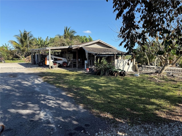 view of front facade with a front lawn and a carport