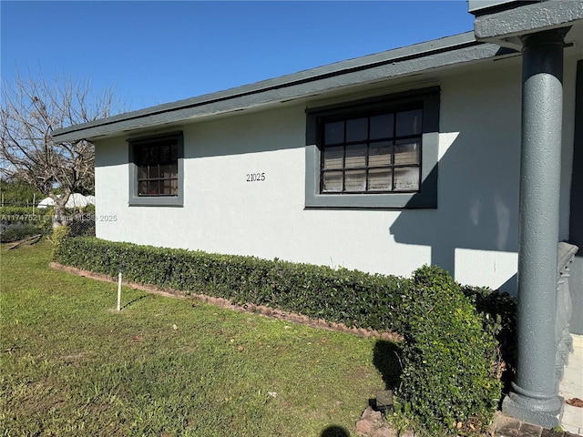 view of property exterior with a lawn