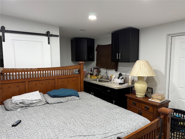 bedroom with sink and a barn door