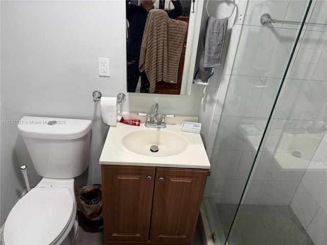 bathroom with vanity, an enclosed shower, and toilet