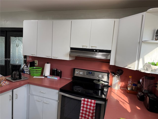 kitchen featuring white cabinetry and electric range