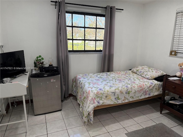 tiled bedroom featuring stainless steel refrigerator