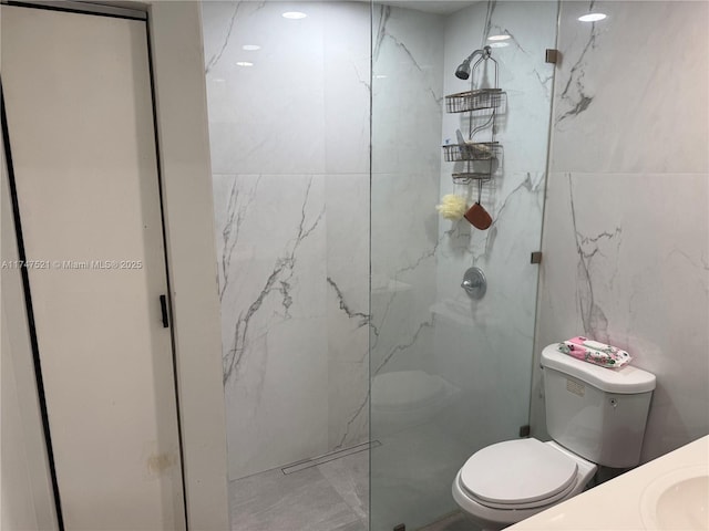 bathroom featuring tile walls, sink, tiled shower, and toilet