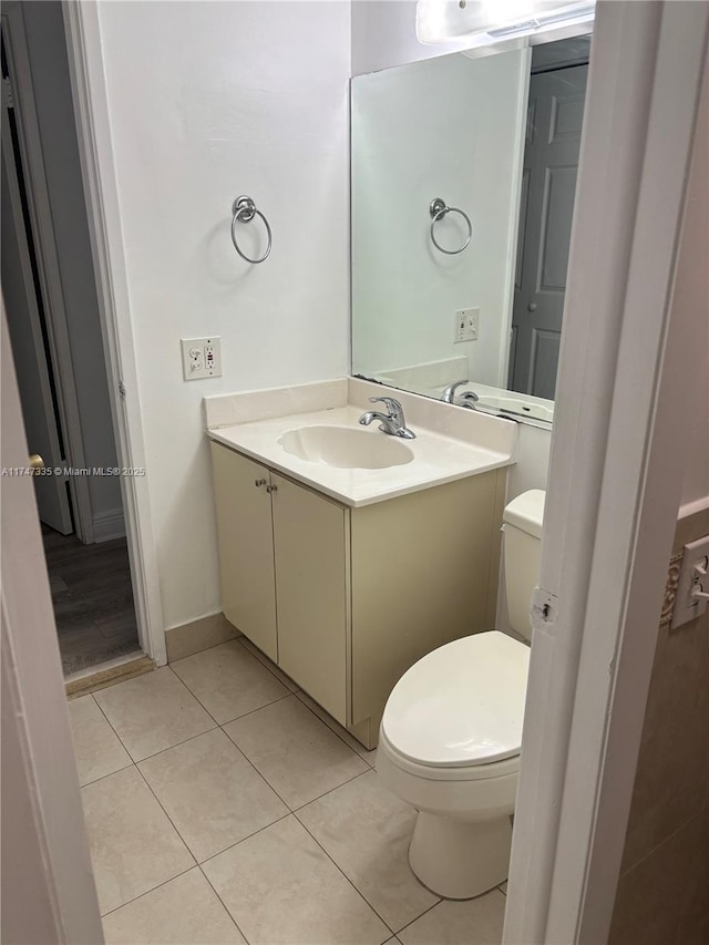 bathroom featuring tile patterned floors, toilet, and vanity