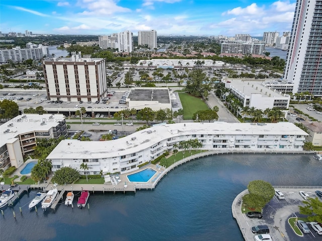 birds eye view of property with a city view and a water view