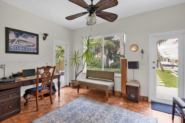 office featuring brick floor and a ceiling fan