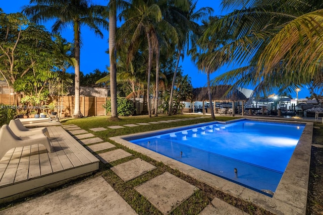 outdoor pool featuring fence