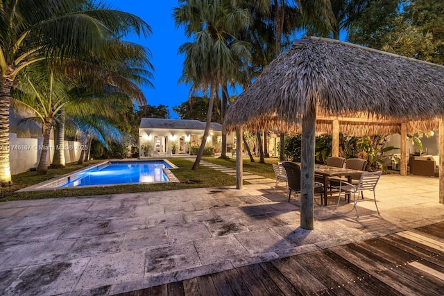 outdoor pool with a patio area, an outdoor structure, a gazebo, and a storage structure