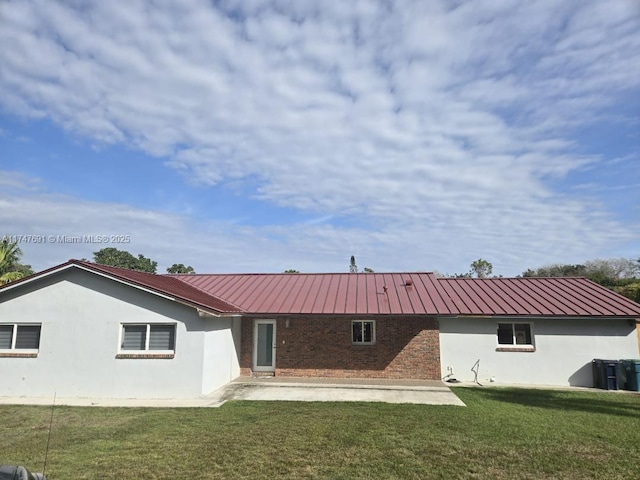 back of house with a yard and a patio area