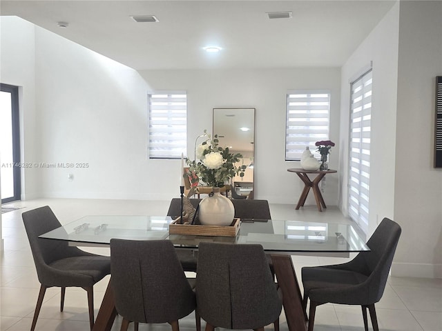 dining area with a wealth of natural light and light tile patterned floors