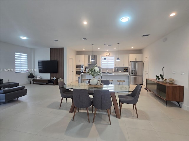 dining room with sink and light tile patterned flooring