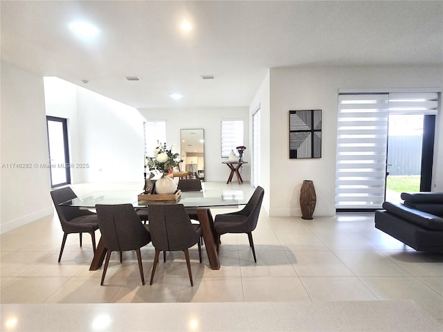 tiled dining area featuring plenty of natural light