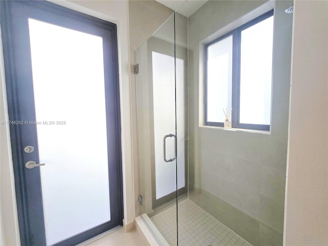bathroom with tile patterned flooring and walk in shower