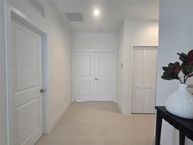 corridor with light tile patterned floors