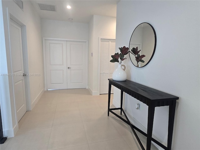 hall featuring light tile patterned floors