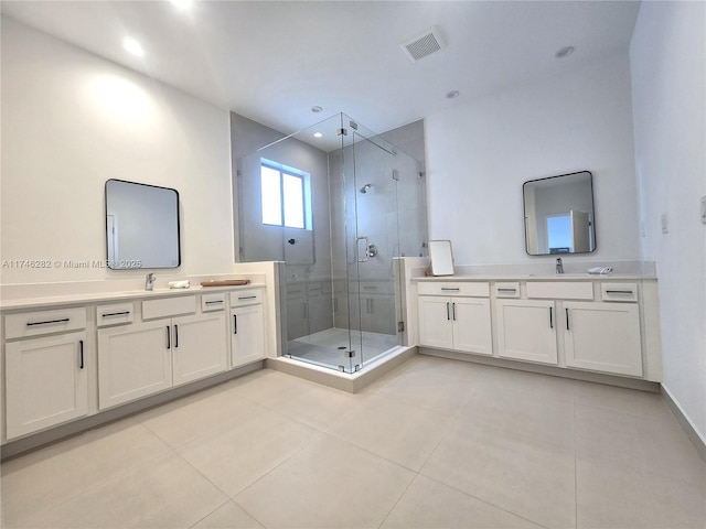 bathroom featuring tile patterned flooring, vanity, and walk in shower