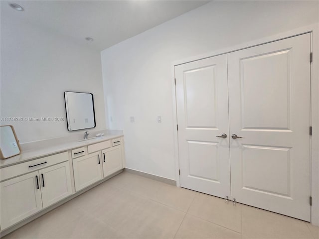 bathroom featuring tile patterned flooring and vanity