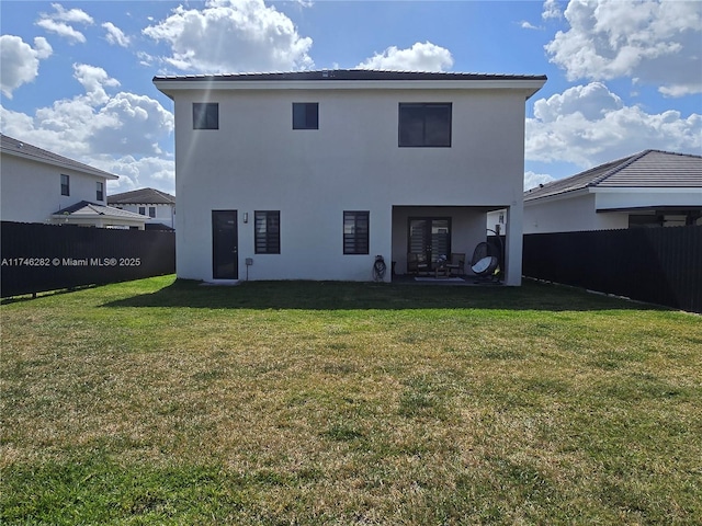 back of house featuring a yard