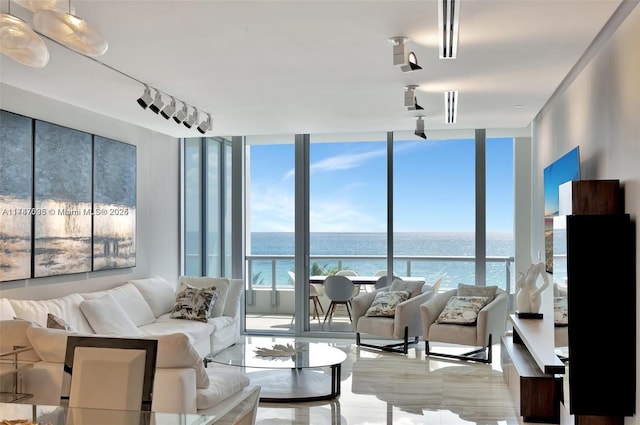 living room featuring rail lighting, plenty of natural light, and floor to ceiling windows