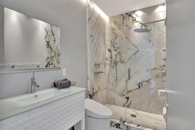 bathroom with vanity, an enclosed shower, and toilet